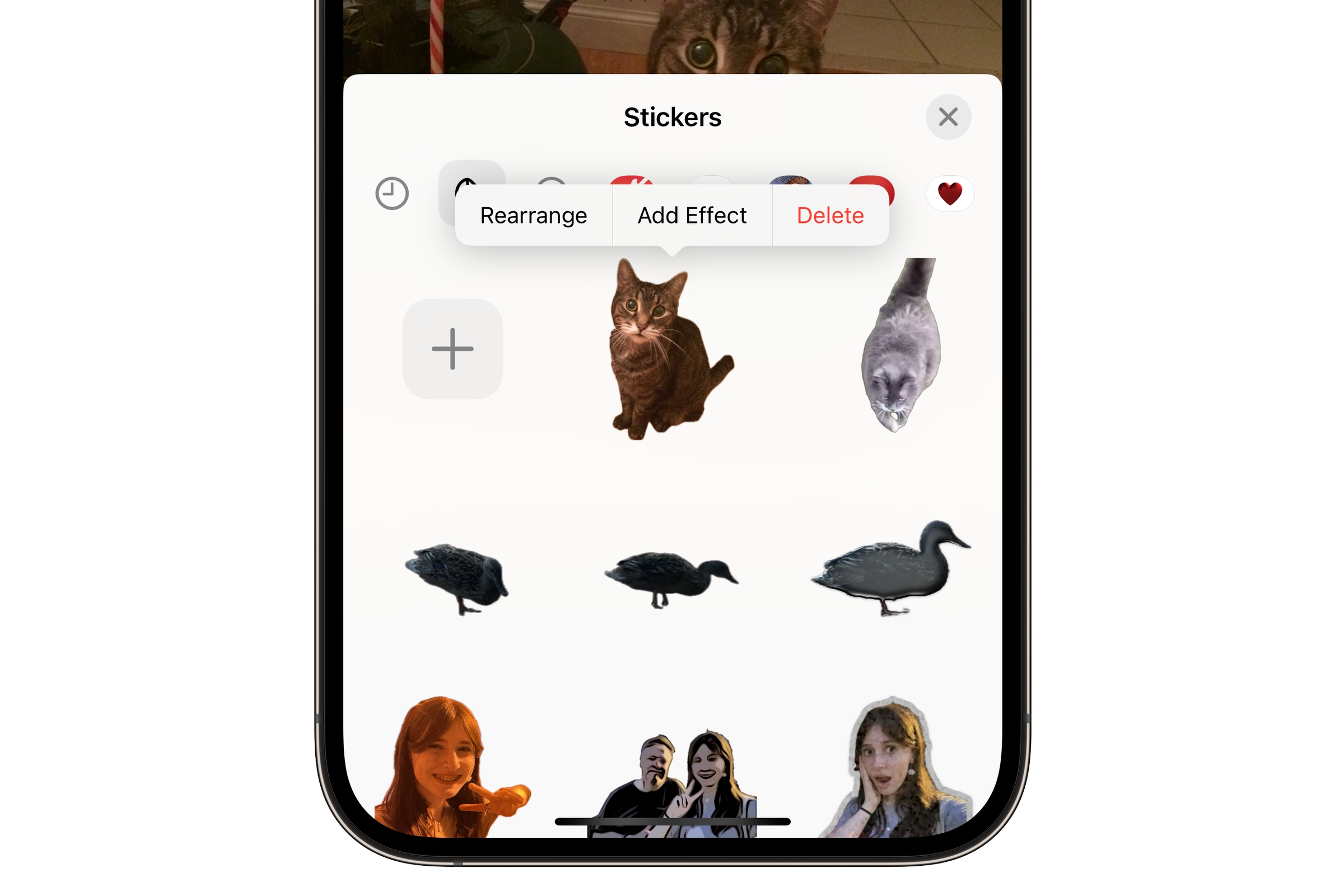 iPhone showing Stickers browser with context menu.