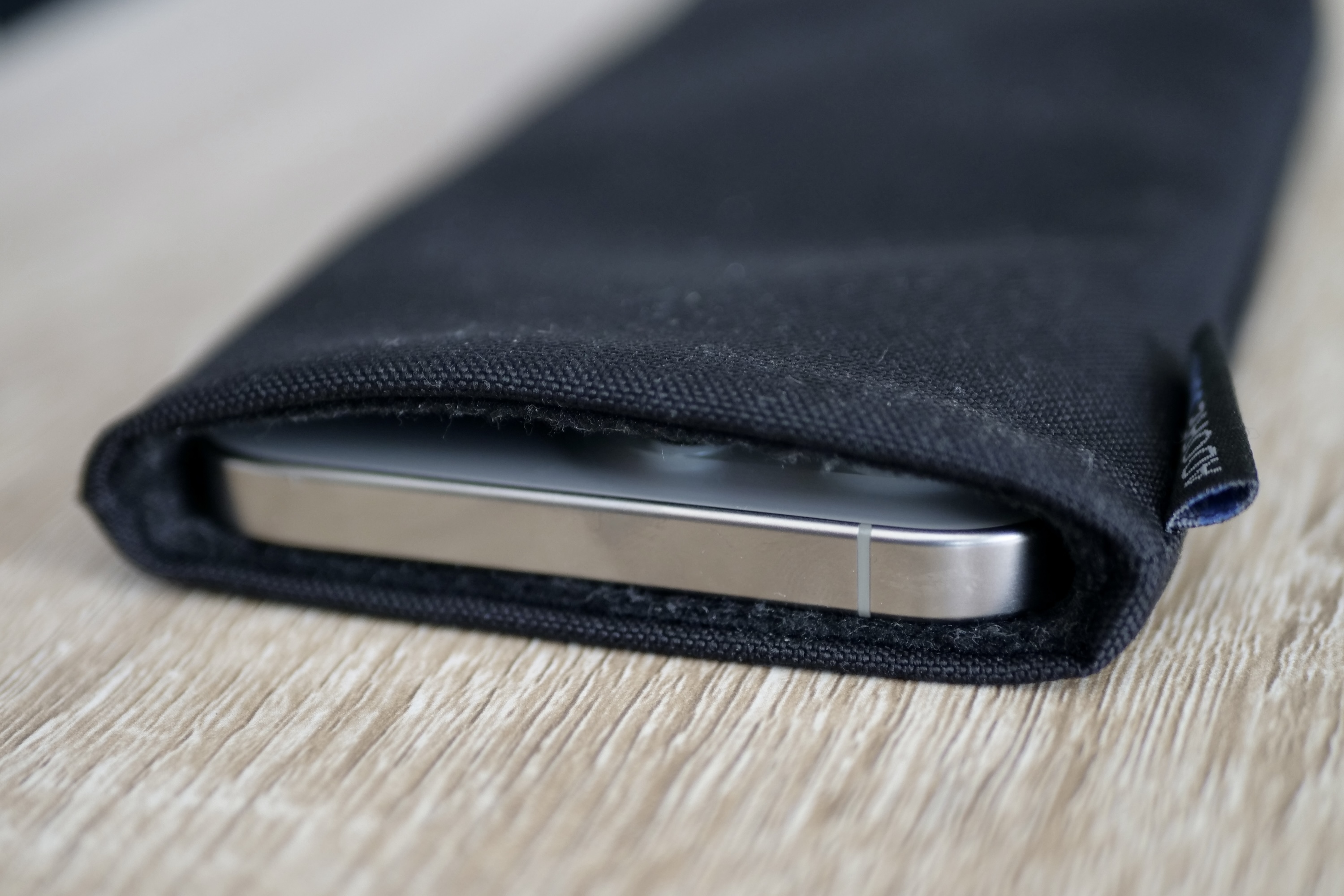 The iPhone 15 Pro Max inside the Adore June pouch.