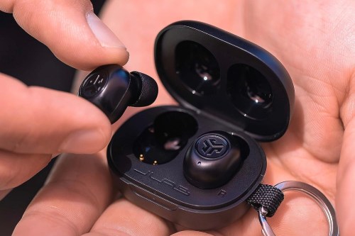 The JLab JBuds Mini in a person's hands.