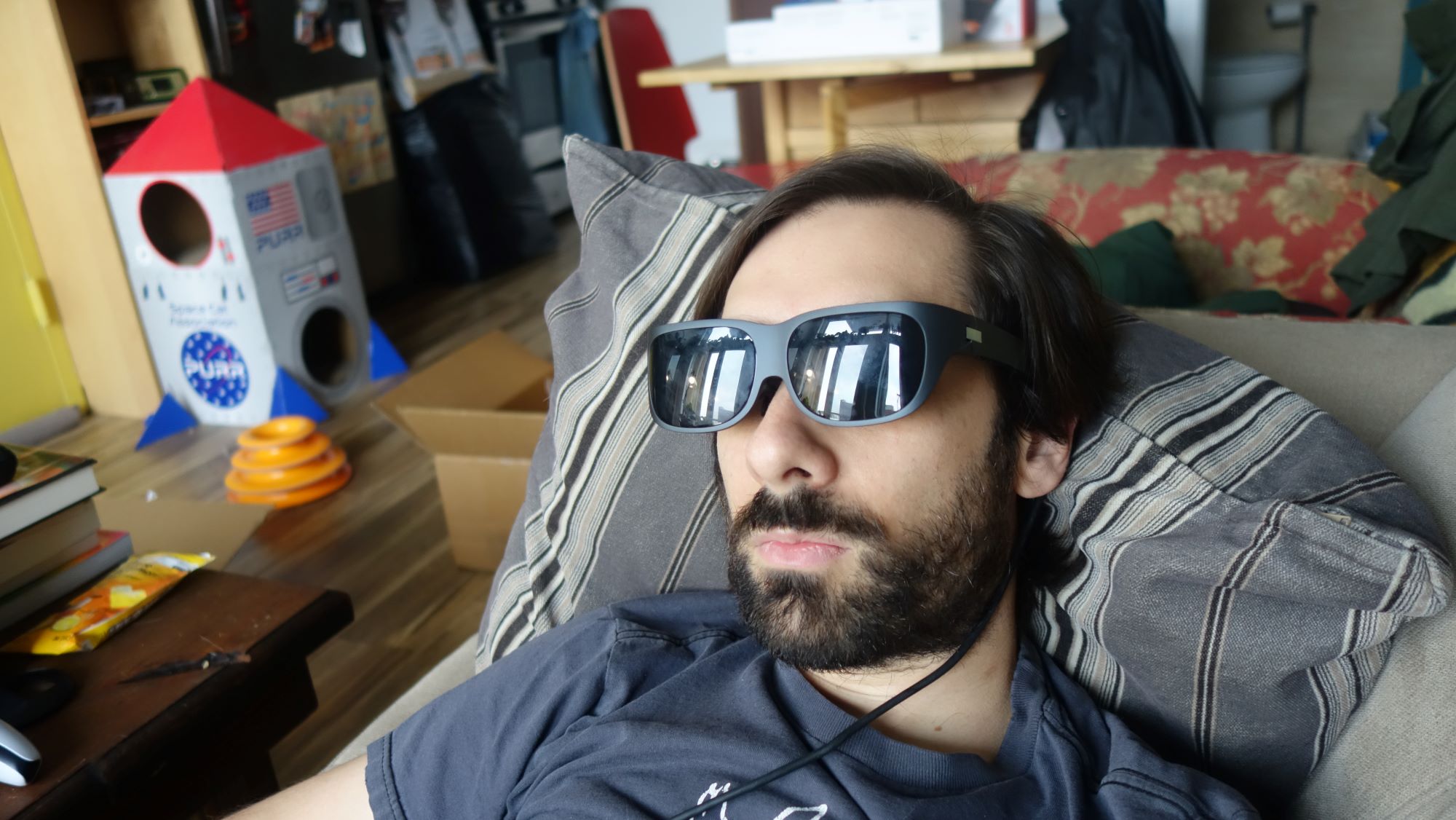 A man lays down while wearing the Legion Glasses.