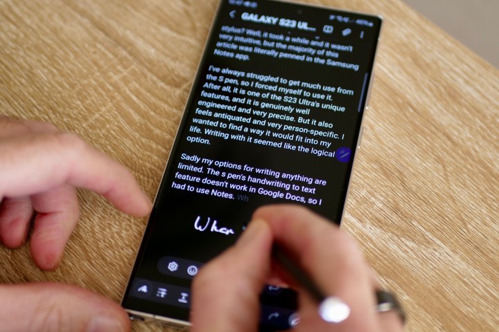 A person using the S Pen stylus on the Galaxy S23 Ultra.