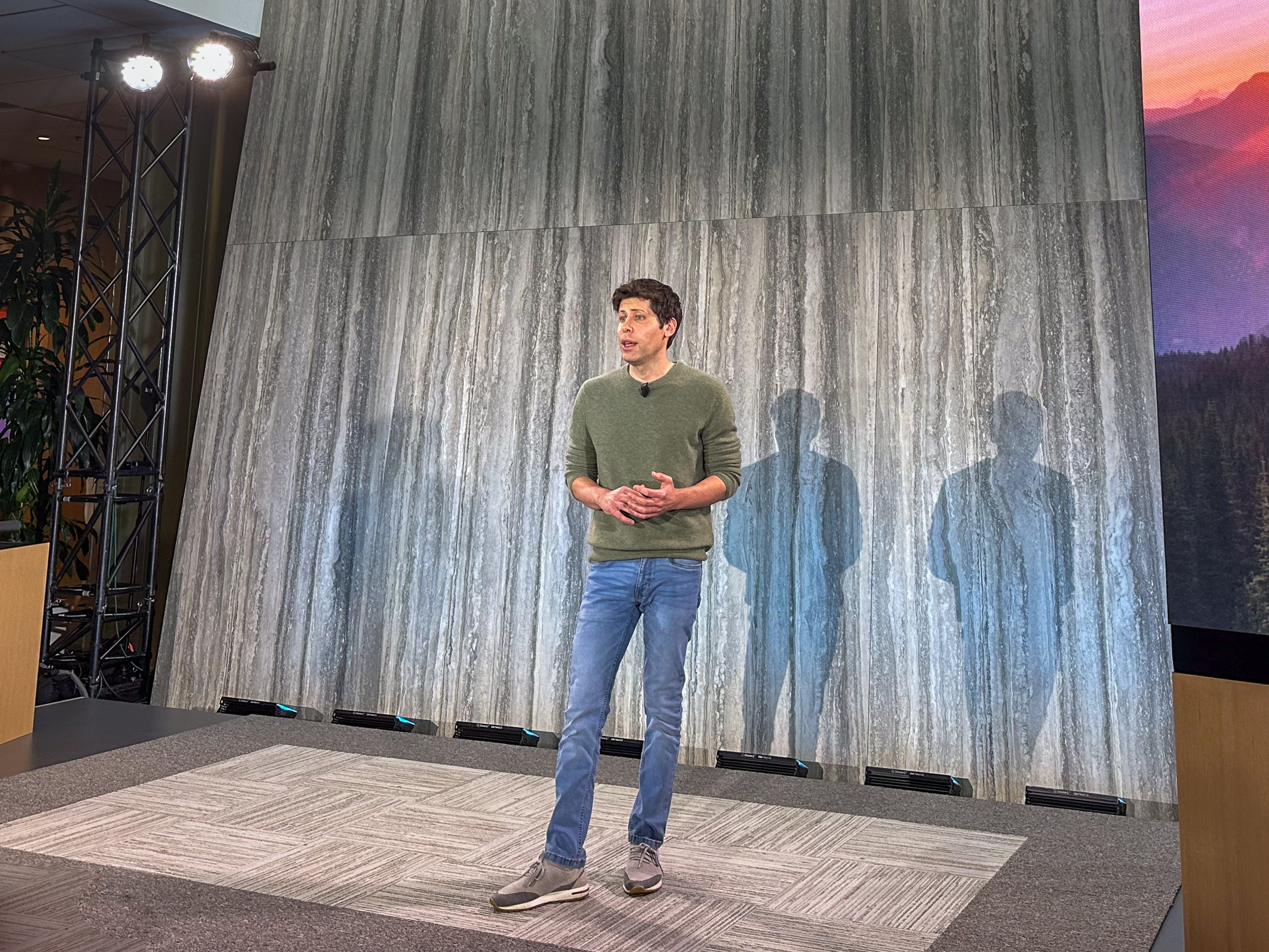 Former OpenAI CEO Sam Altman standing on stage at a product event.