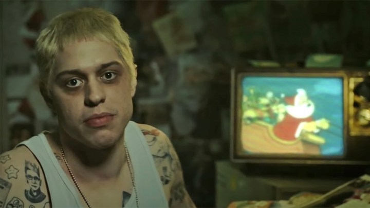 Pete Davidson in a white tank and dark circles around his eyes playing the character Stu in the SNL Digital Short.