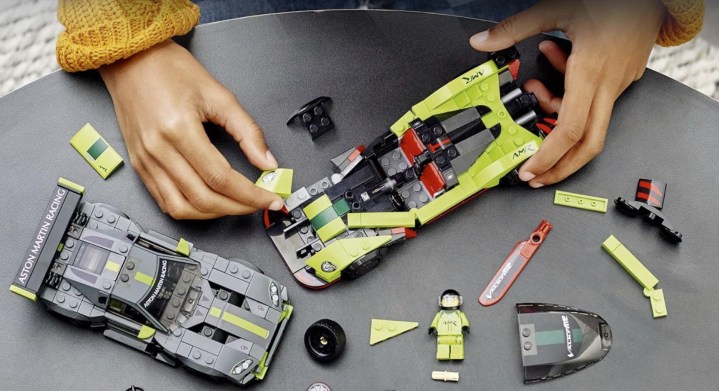 Someone assembling the LEGO Speed Champion Aston Martin.