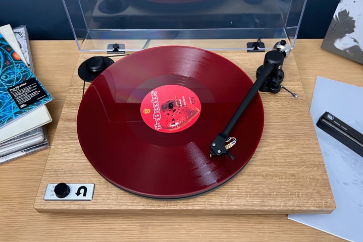 The U-Turn Orbit Special turntable with a red vinyl record on it.