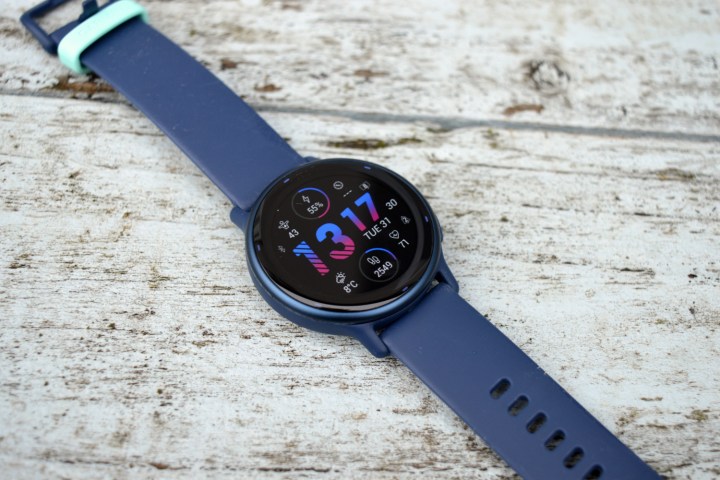 The Garmin Vivoactive 5 sits on painted wood, face up.