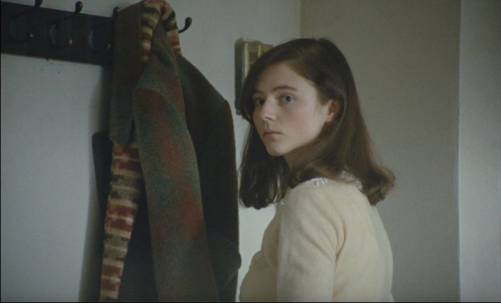 A young woman looks to her side in Eileen.