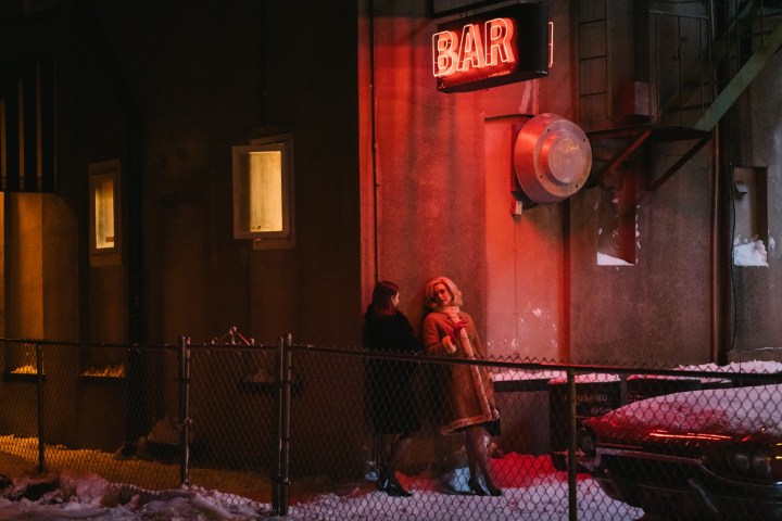 Two women chat outside a bar in Eileen.
