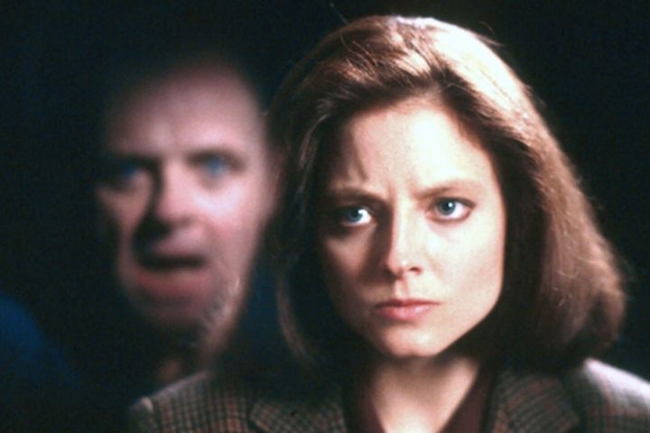 Anthony Hopkins in the reflection and Jodie Foster looking at him in The Silence of the Lambs