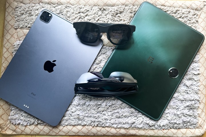 Two pairs of AR glasses on top of an iPad and an Android tablet.