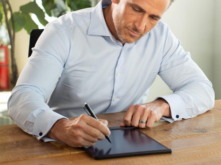 A man writes on the Boogie Board Blackboard smart notebook.