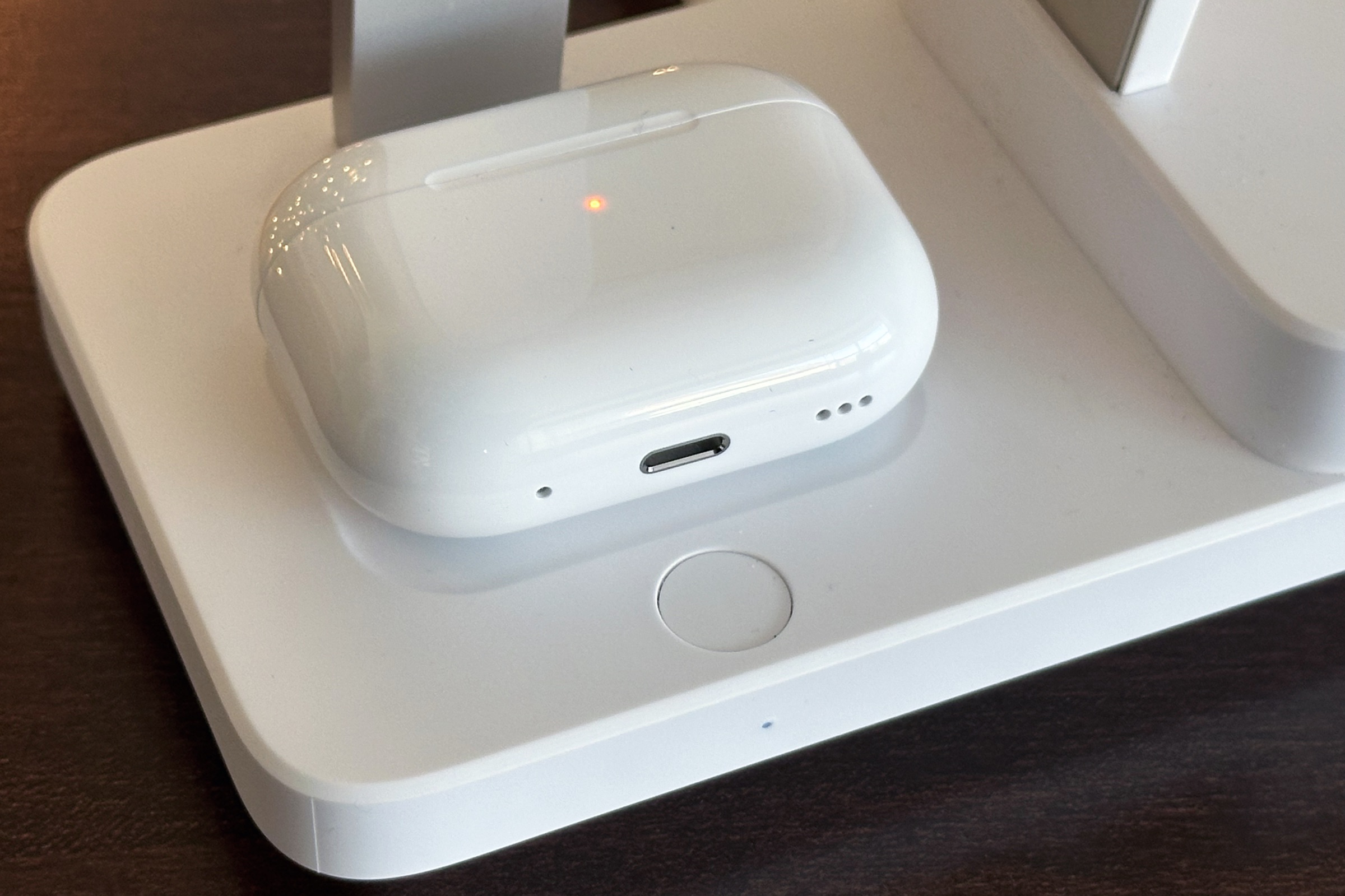 Closeup of AirPods Pro charging on ESR 6-in-1 charging stand and button to turn off CryoBoost.