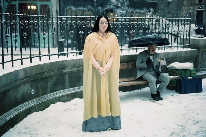 Emma Stone wears a yellow parka in Poor Things.