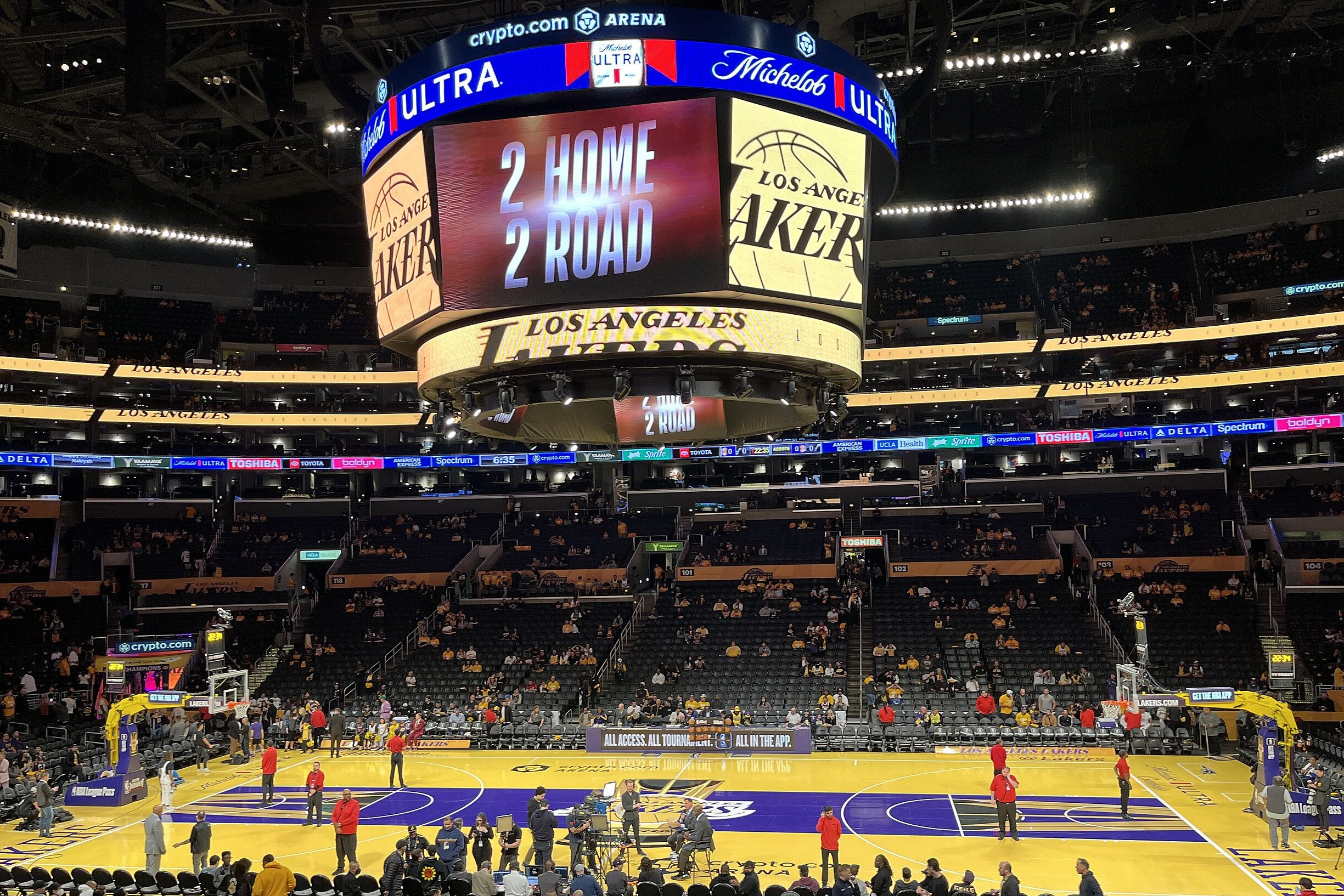 People stand on the Lakers' In-Season court.