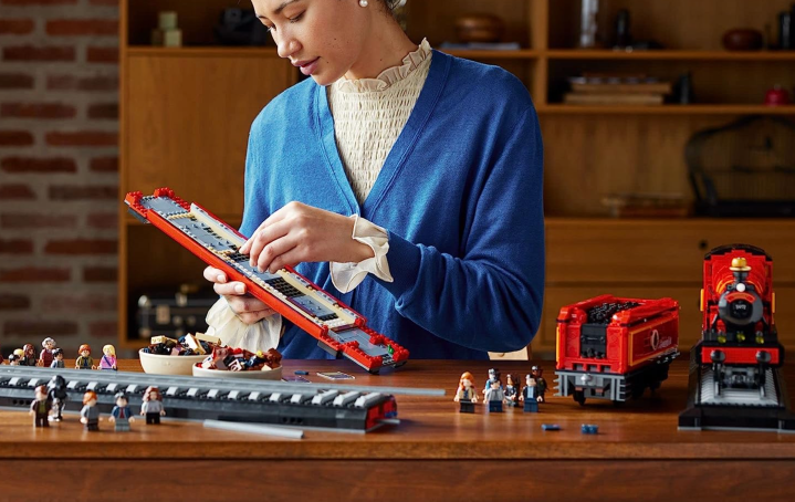 Someone building the Lego Harry Potter Hogwarts Express Collector’s Edition.