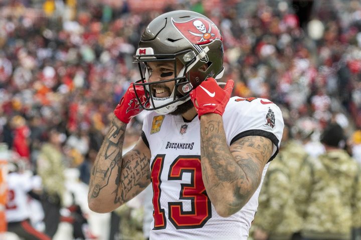 Mike Evans straps his football helmet to his head.