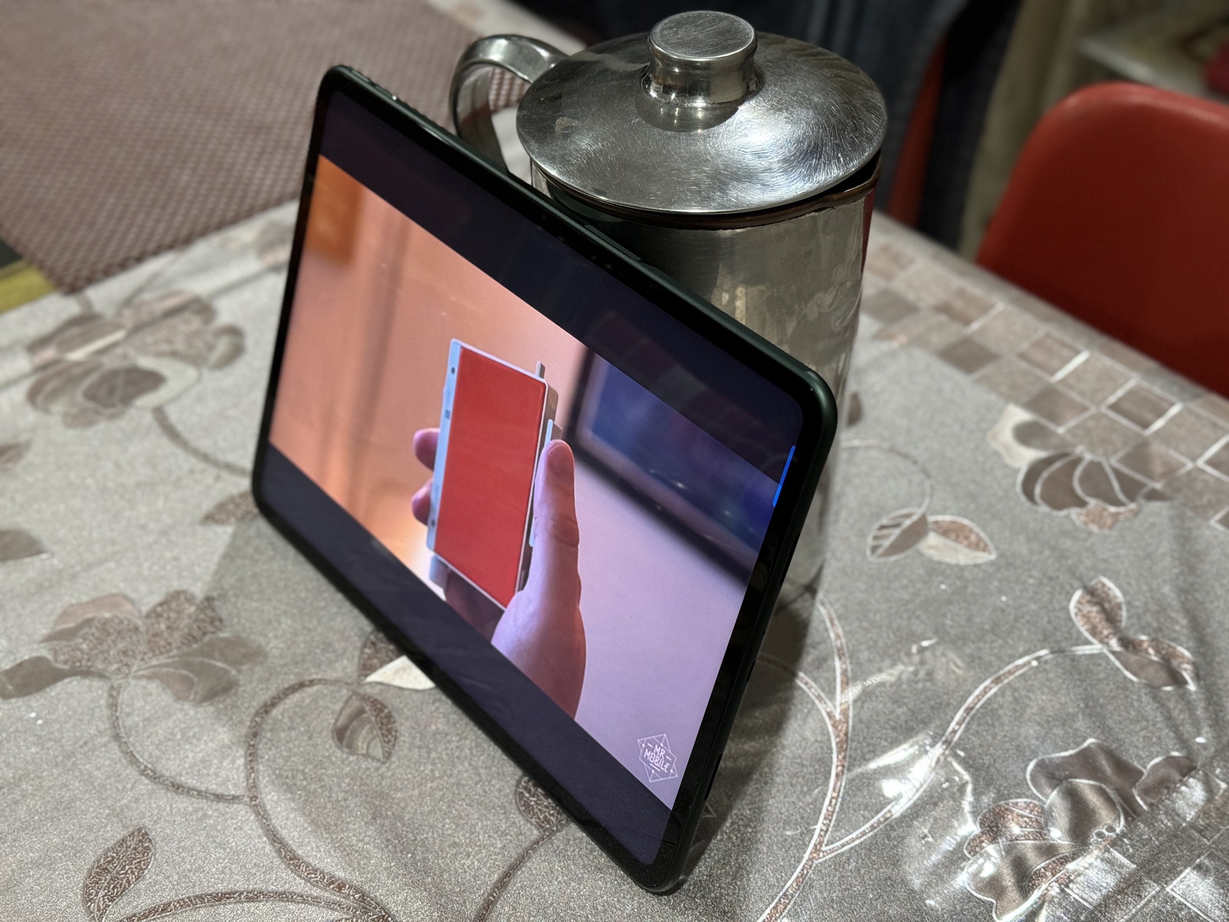 OnePlus Pad propped up with the help of a jug.