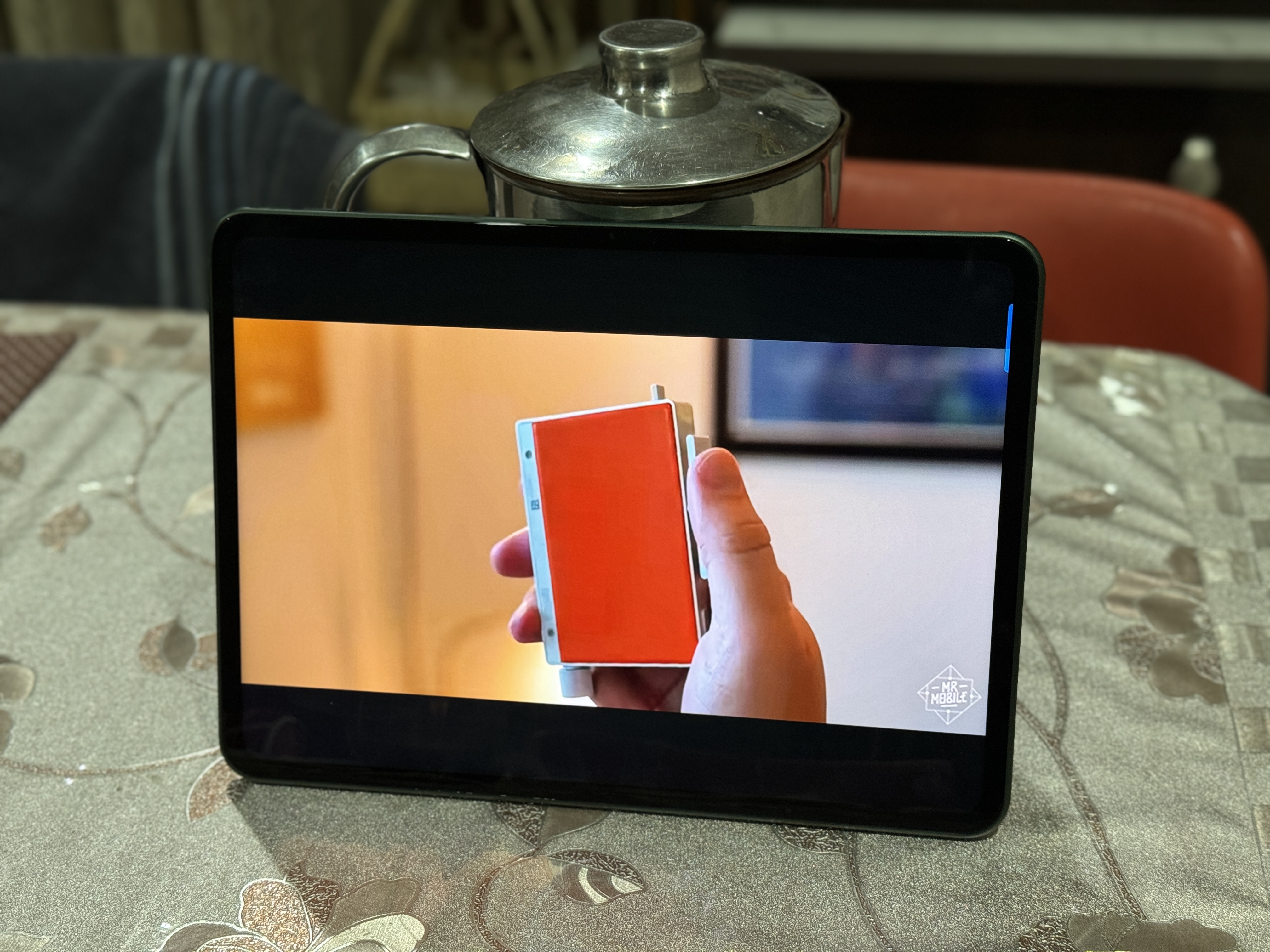 OnePlus Pad propped up with the help of a jug.