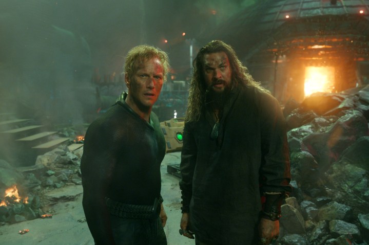 Orm and Arthur stand near rubble in Aquaman and the Lost Kingdom.