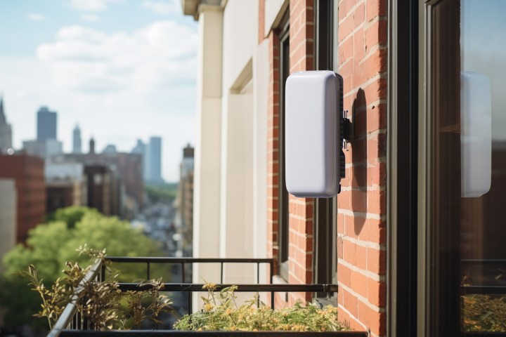 Helium Mobile Outdoor Hotspot mounted on wall ouside an apartment balcony.
