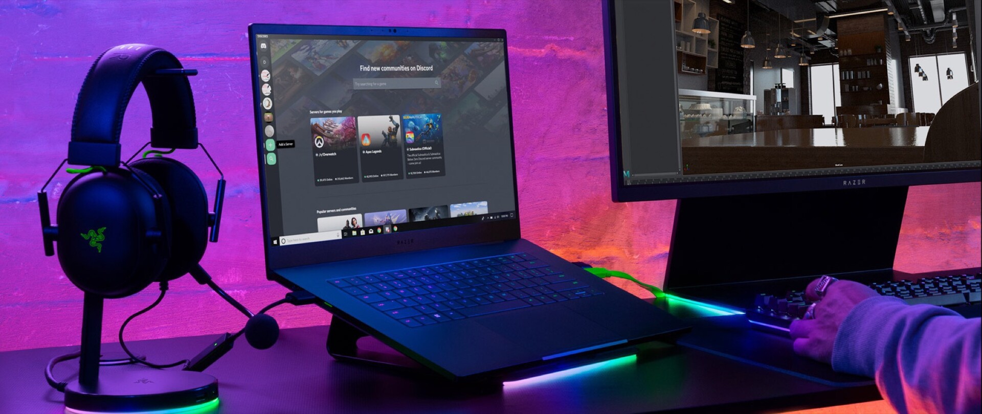 Press image of the Razer Blade 15 2023 laptop placed next to a headphone and display.