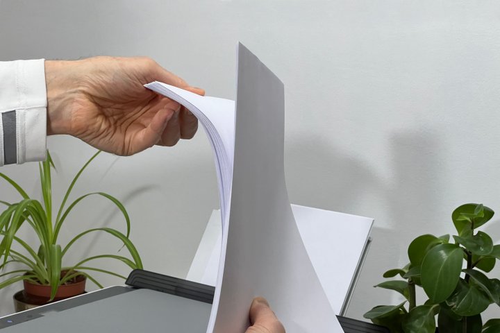 Riffle printer paper to help prevent sheets from sticking together.