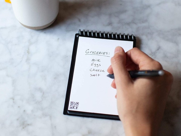 Using the Rocketbook Mini smart reusable notebook on a table.