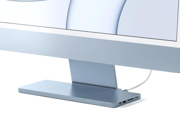A Satechi USB-C Slim Dock for iMac at the foot of an Apple iMac.
