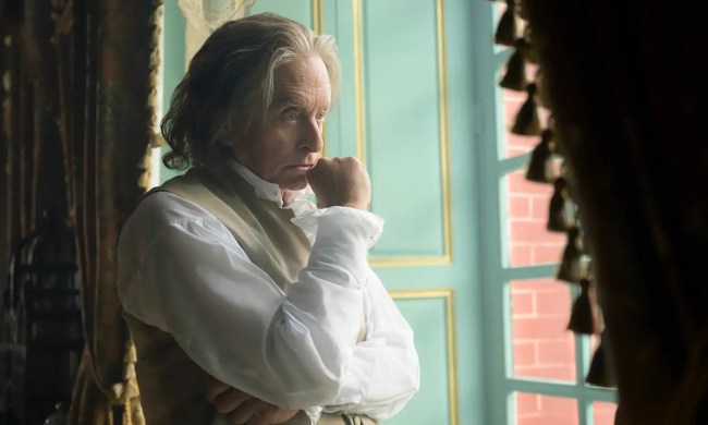 Michael Douglas as Benjamin Franklin stands by a window pondering, fist up to his chin in a scene from Franklin.
