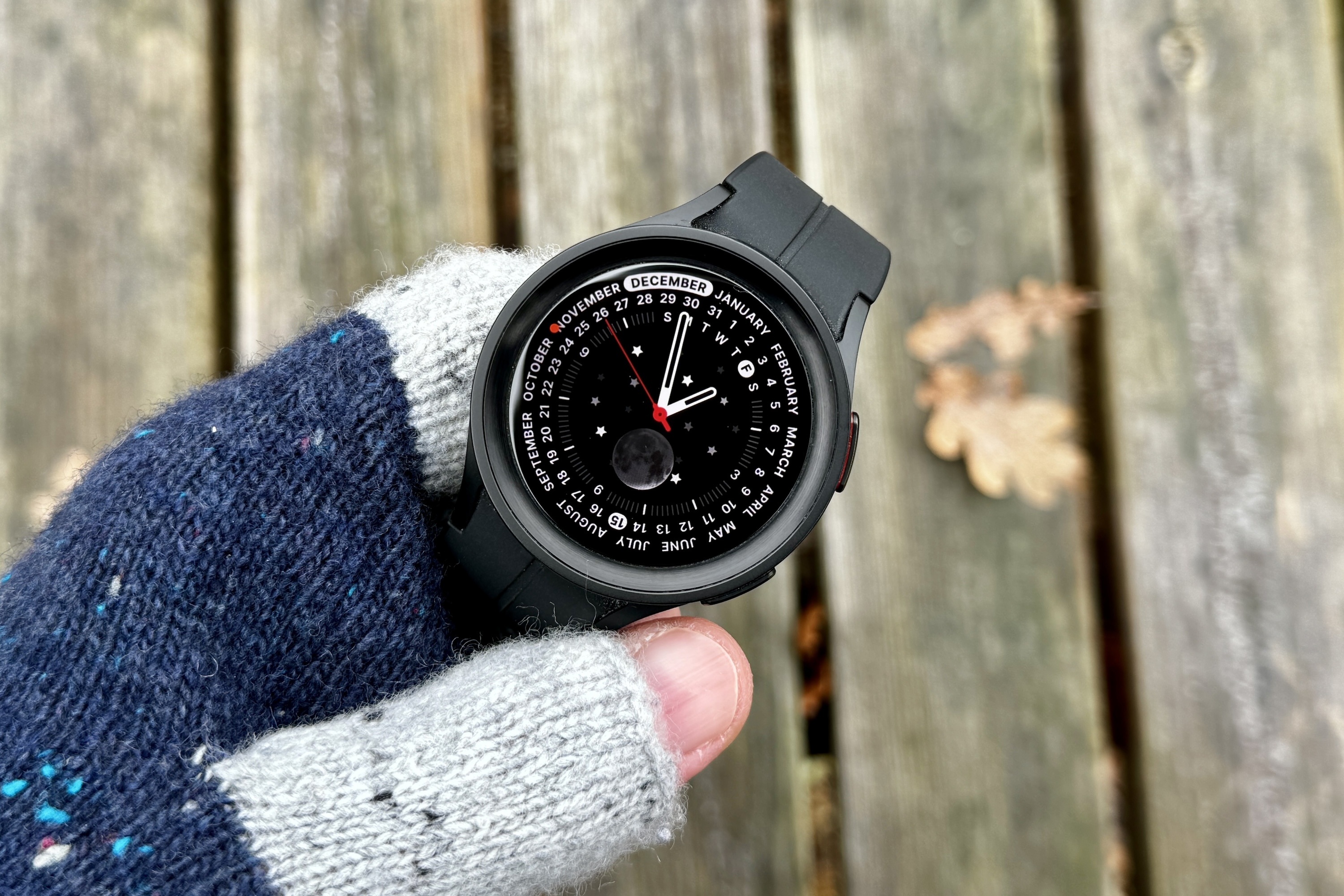 A person holding the Samsung Galaxy Watch 5 Pro.