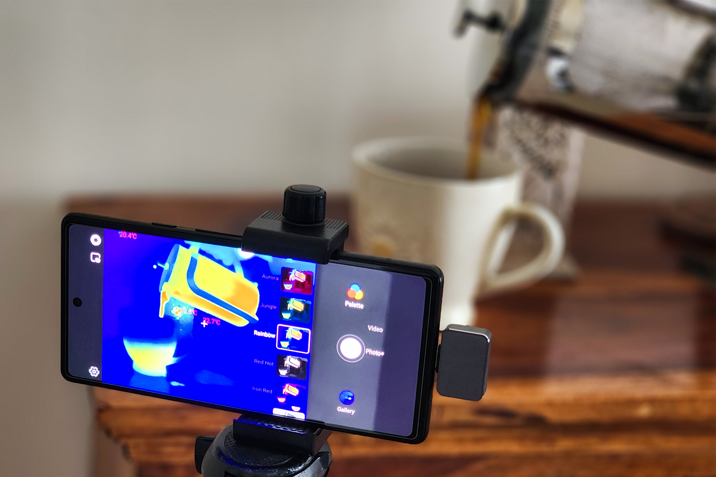 Infiniray P2Pro infrared thermal imaging camera used to see the temperature of coffee being poured from a french press into a ceramic mug.