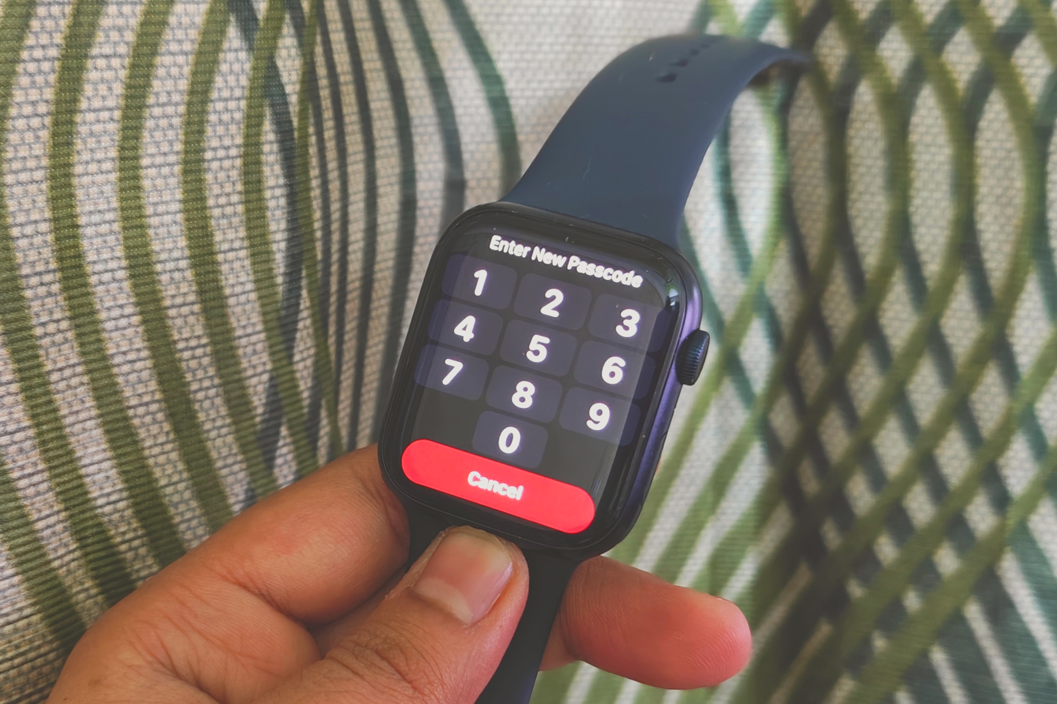 An Apple Watch displaying a passcode prompt.
