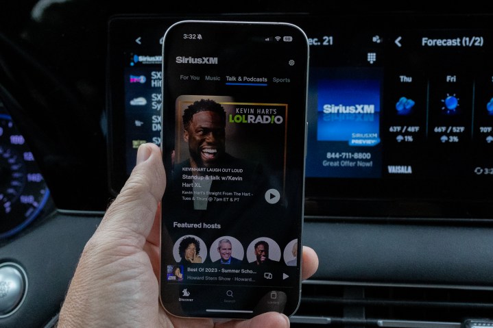 Kevin Hart's SiriusXM show as seen in the phone app in front of SiriusXM in a car.
