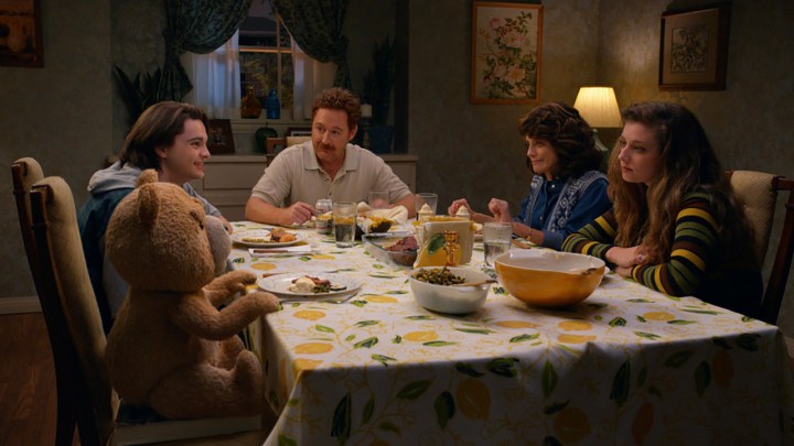 The Bennett family sitting around the dinner table in a scene from ted on Peacock.