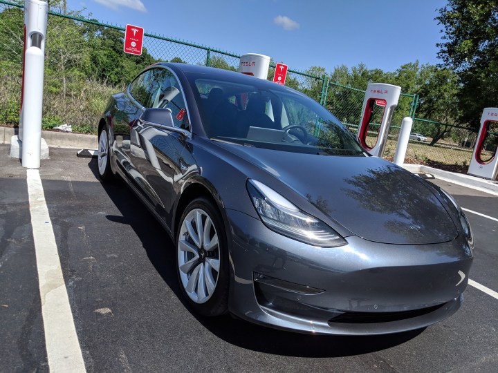 A Tesla Model 3 at a Supercharger station.