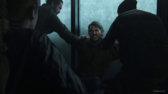 Two characters restrain Joel in The Last of Us Part 2 Remastered.