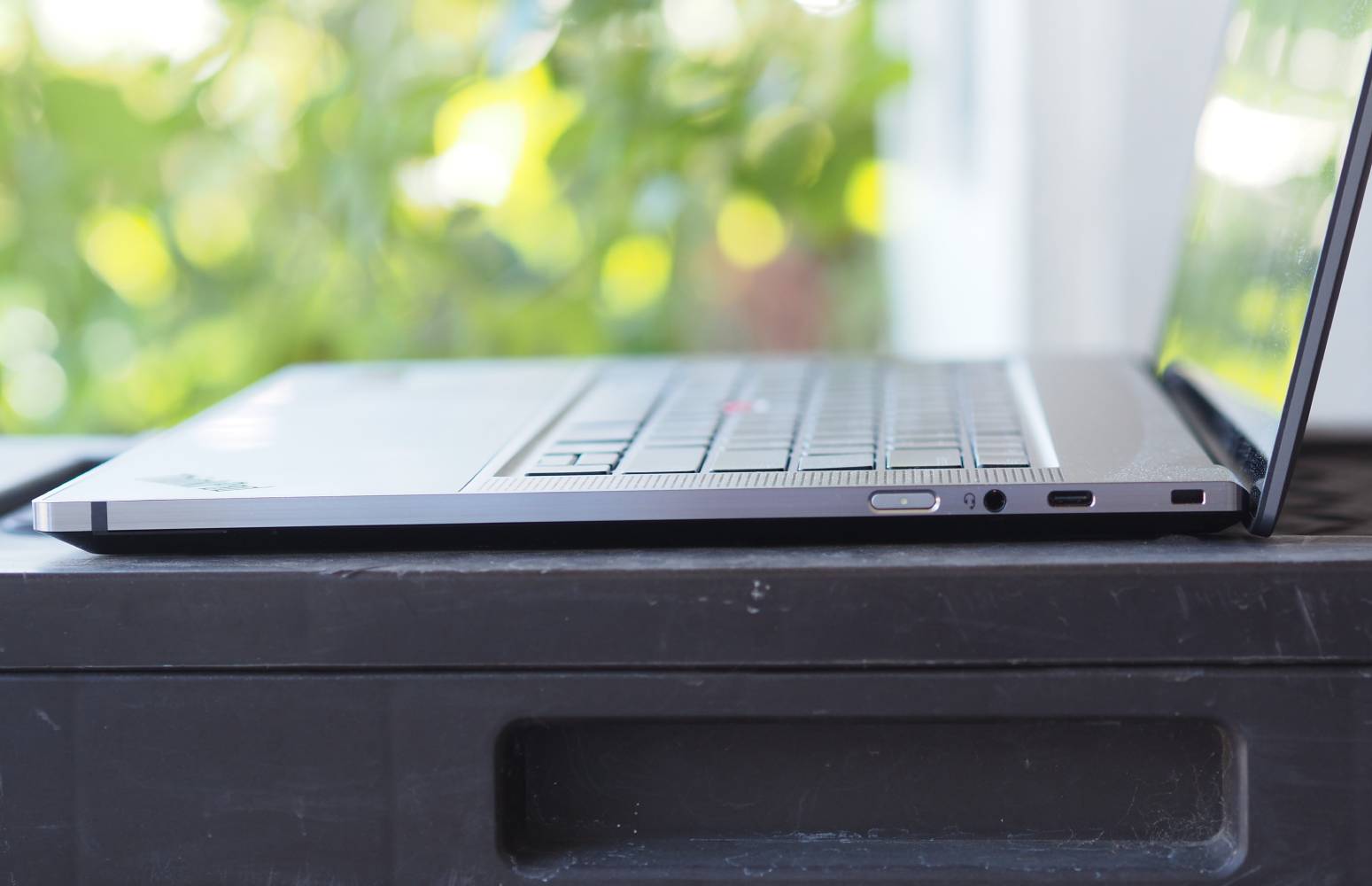 The side profile of the ThinkPad Z16 Gen 2 on a table outside.