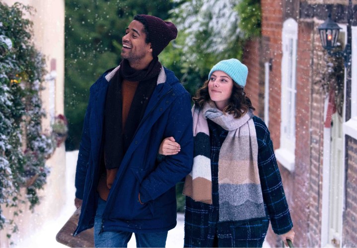 A man and a woman walk through snow in This is Christmas.