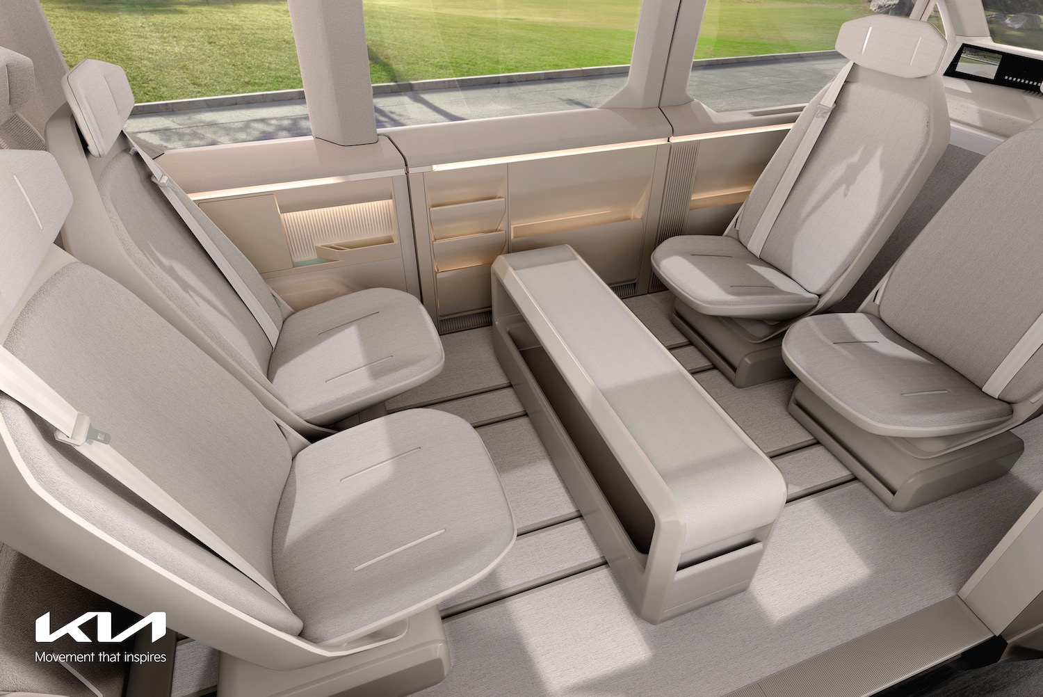 Interior of a Kia Concept PV5 with inward-facing seats.