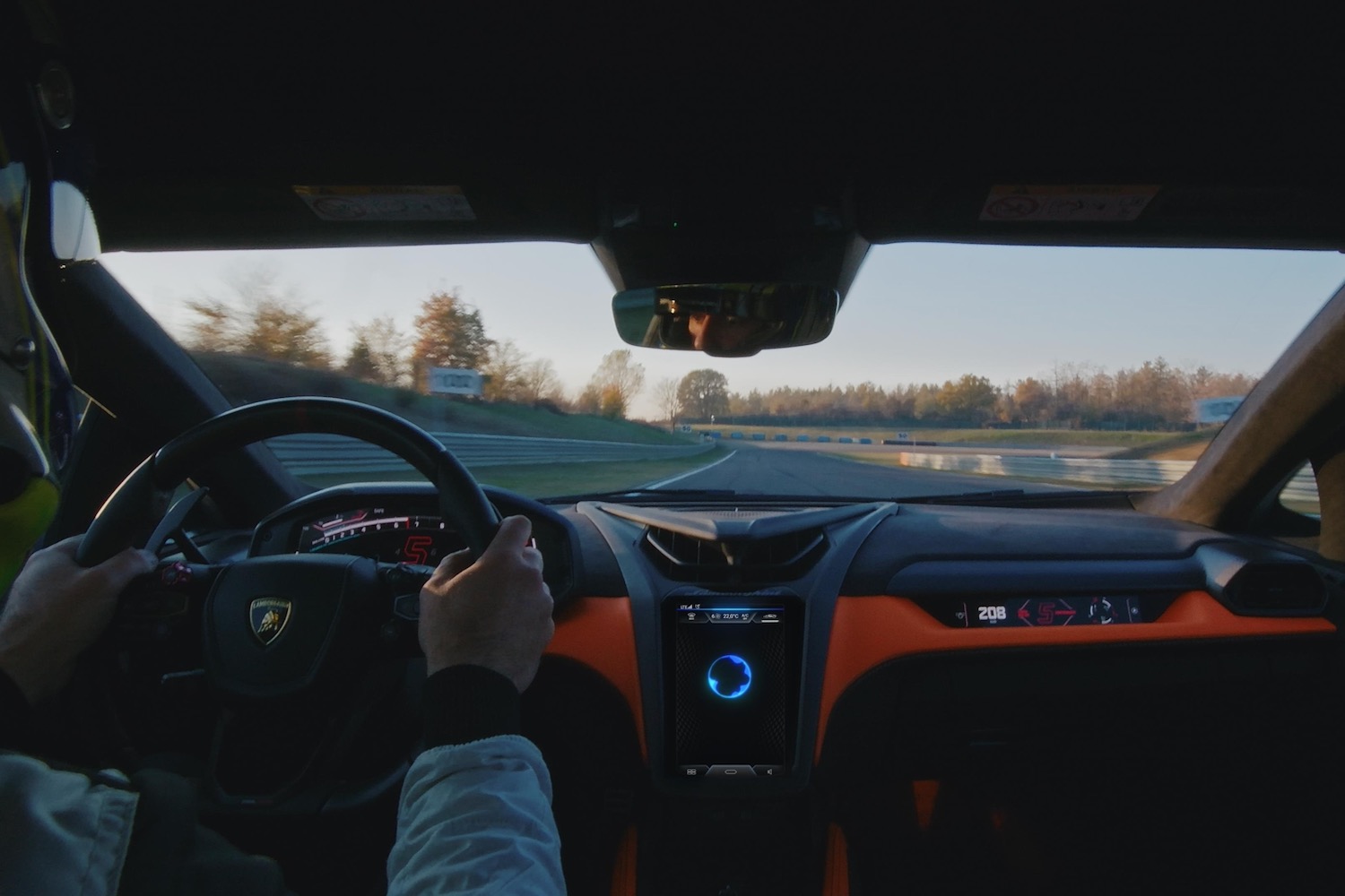 Driver's view of a Lamborghini Revuelto on a racetrack.