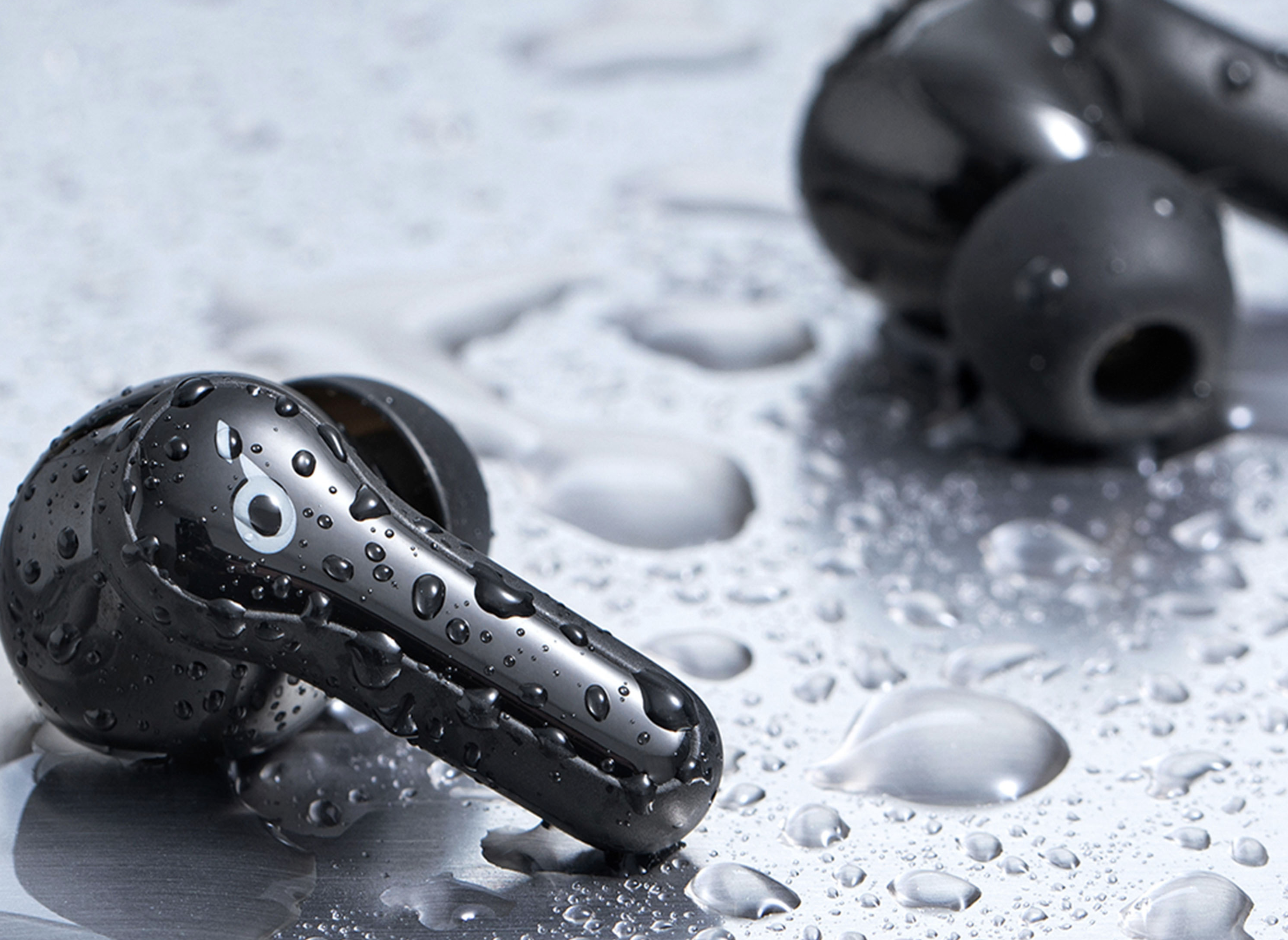 The Anker Soundcore Life Note C wireless earbuds with droplets of water on them.