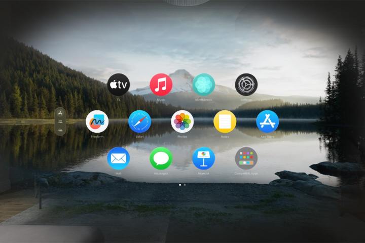 A set of app icons appear against a backdrop of a lake and mountains using the Environments feature in Apple's Vision Pro headset.