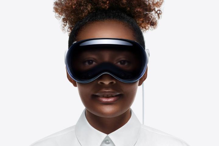 A person wears an Apple Vision Pro headset. Their eyes are visible through the front of the device.