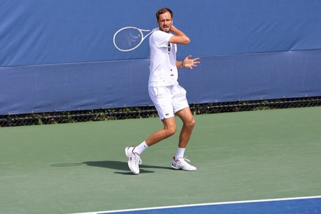 Daniil Medvedev practices a backhand shot on the tennis court.