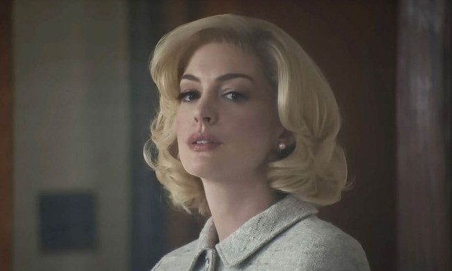 Anne Hathaway as Rebecca looking intently off-camera in Eileen.