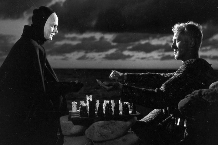 Max von Sydow and Bengt Ekerot looking at each other with a chess board between them in "The Seventh Seal" (1957).