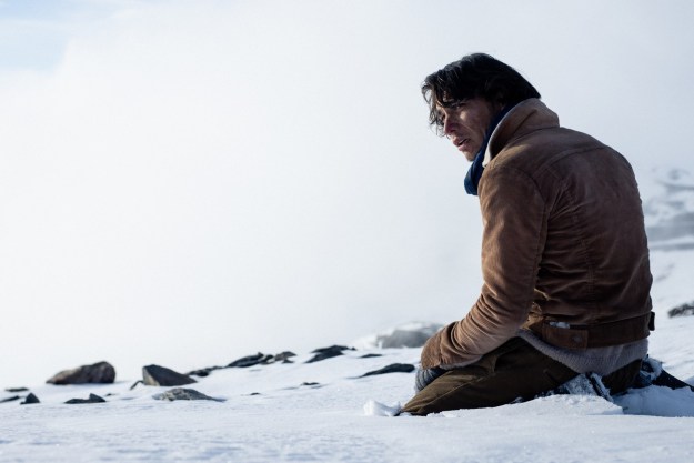 Enzo Vogrincic Roldán sits in the snow in a still from Society of the Snow