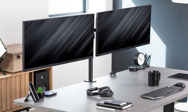 The Vivo Dual Ultrawide Monitor Mount on a desk, holding two monitors.