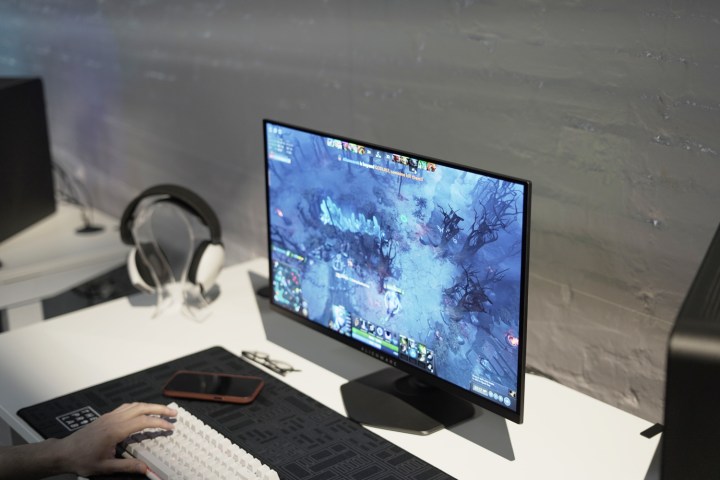 The Alienware 27 QHD QD-OLED being played on a table.