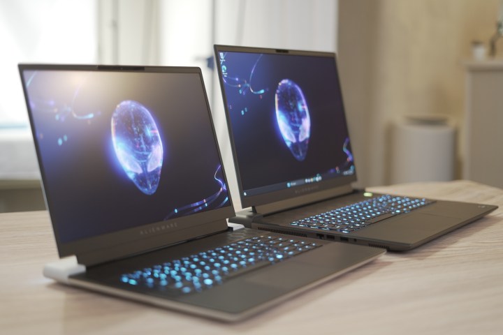 The Alienware x16 and m18 open on a table.